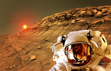 Astronaut spaceman helmet planet Mars surface martian colony space landscape. Elements of this...