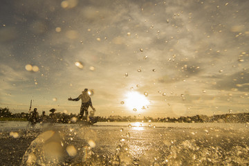 Silhouette of traditional fisherman in wooden boat on Inle lake