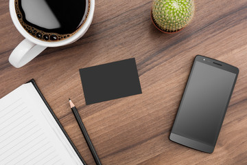 Brown desk with coffee, phone, notebook and cactus - obrazy, fototapety, plakaty