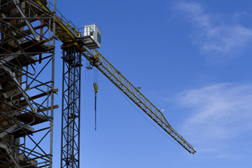 Naklejka premium Construction site with crane on sky background. Low angle view.