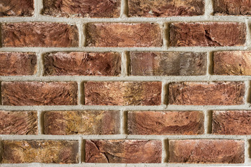 Red brick wall fragment background texture. Close up