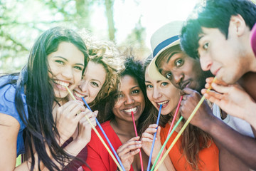 Group of multi race friends enjoying drink outdoor summer party