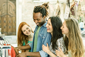 Group of friends having fun in weekly clothes market 