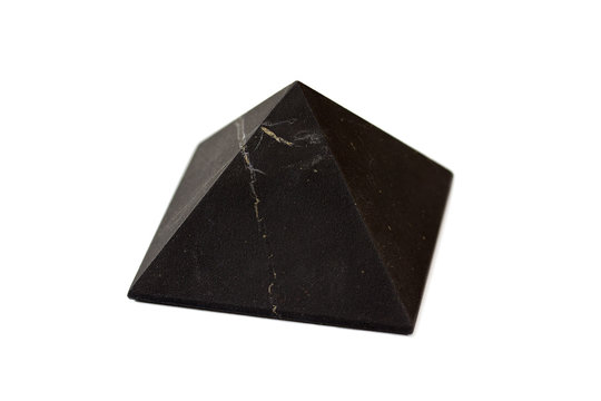A pyramid of shungite isolated on white background.