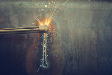 Metal cutting with acetylene torch.
