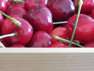 Border of fresh cherries on wooden background with copy space