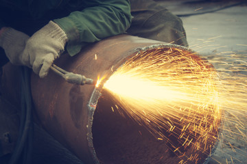 Metal cutting with acetylene torch.