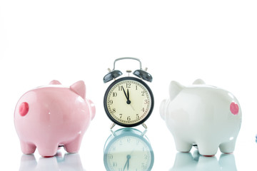 Alarmclock with piggybank on white background