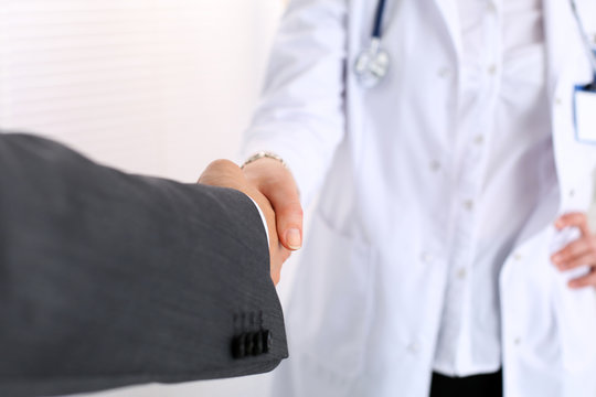 Female medicine doctor shake hand as hello