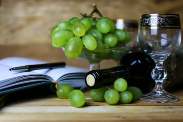 wine bottle book and glass grape