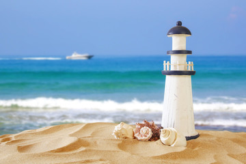 Image of tropical sandy beach, lighthouse and seashells