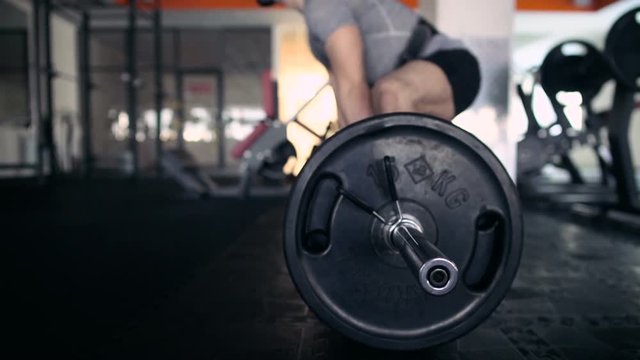 Young Male Athlete Exercising With A Barbell. Deadlifts