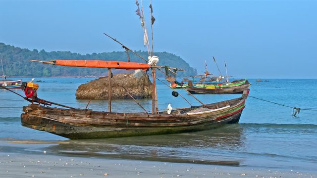 Fisherman boats on sand and anchored on the Ngapali beach, Myanmar