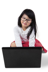 Attractive little girl with notebook computer