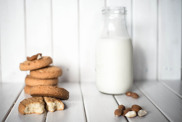 Almond milk with cookies on white wooden background. Cookies and milk