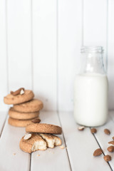 Almond milk with cookies on white wooden background. Cookies and milk