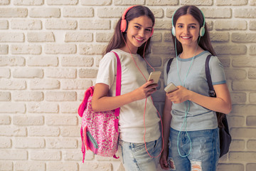 Attractive teenage girls with gadgets © georgerudy