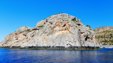 Fototapeta na wymiar beautiful bay and rocks view from sea Rhodes Greece sunny day