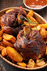 Grilled barbecue meat with baked potato and dip