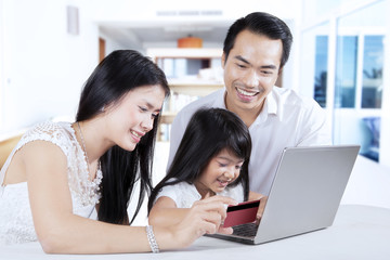 Family using credit card for paying online