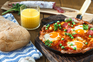 Spanish cuisine. Eggs on vegetables, Andalusian style. Huevos a la flamenca.