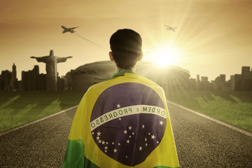 Man with Brazilian flag on the road