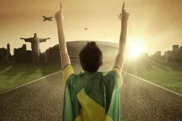 Foto op Canvas Man with Brazilian flag raises his hands © Creativa Images