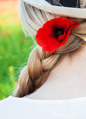 Naklejka premium poppy flower in the girl's hair
