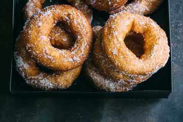Homemade donuts with sugar and sugar powder in old metal background. 