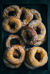 Homemade donuts with sugar and sugar powder in old metal background. 