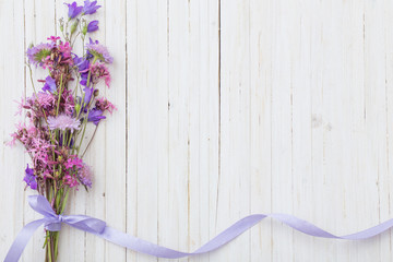 Fototapeta na wymiar bluebel flowers om white wooden background