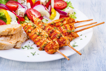 Grilled chicken on a stick with vegetables