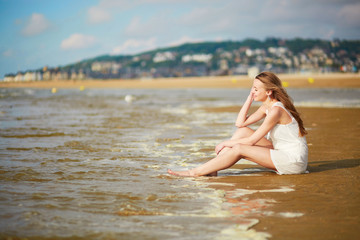 Fototapeta na wymiar Beautiful young woman enjoying her vacation by ocean or sea