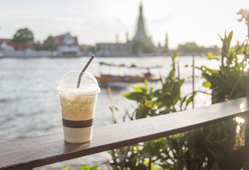 cup of white chocolate with blur river view background