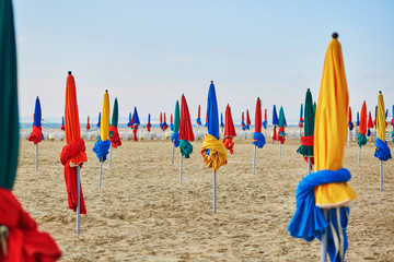 The famous colorful parasols on Deauville Beach, Normandy - obrazy, fototapety, plakaty