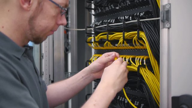 IT engineer plug in ethernet cable