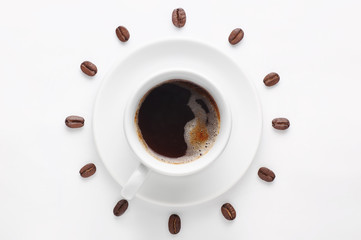 Coffee cup and coffee beans against white background forming clock dial viewed from top