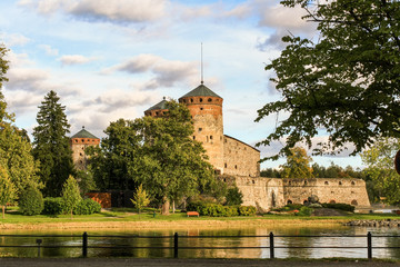 Ancient fortress Olavinlinna in Savonlinna in Finland among the trees a summer day.