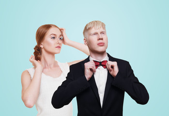 Well-dressed couple in luxury clothes isolated