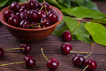 Fresh cherries in bowl on table
