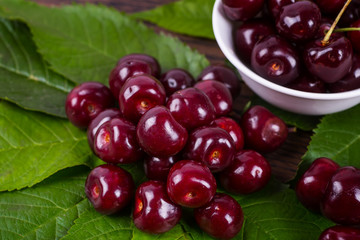 Fresh cherries in bowl on table