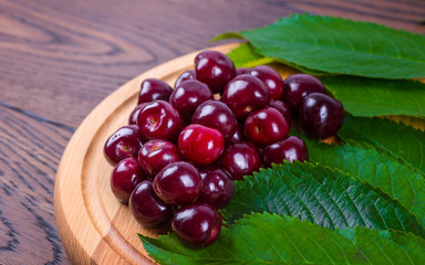 Fresh cherries in bowl on table
