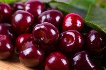 Fresh cherries in bowl on table