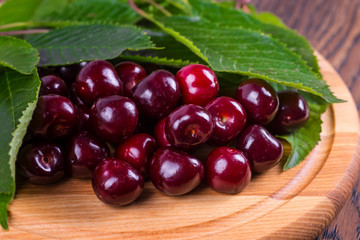Fresh cherries in bowl on table