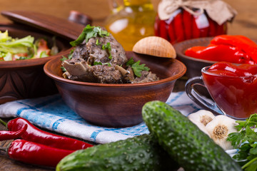 Roasted meat and vegetables on a wooden background