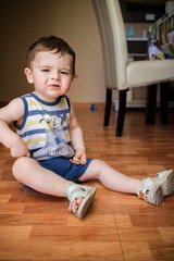 Baby boy sitting on the floor