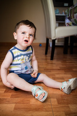 Baby boy sitting on the floor