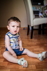 Baby boy sitting on the floor