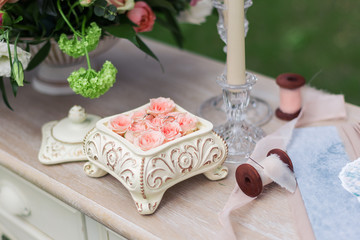 Pink roses in a ceramic box on the table
