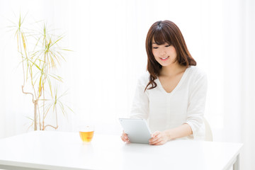 attractive asian woman using tablet computer